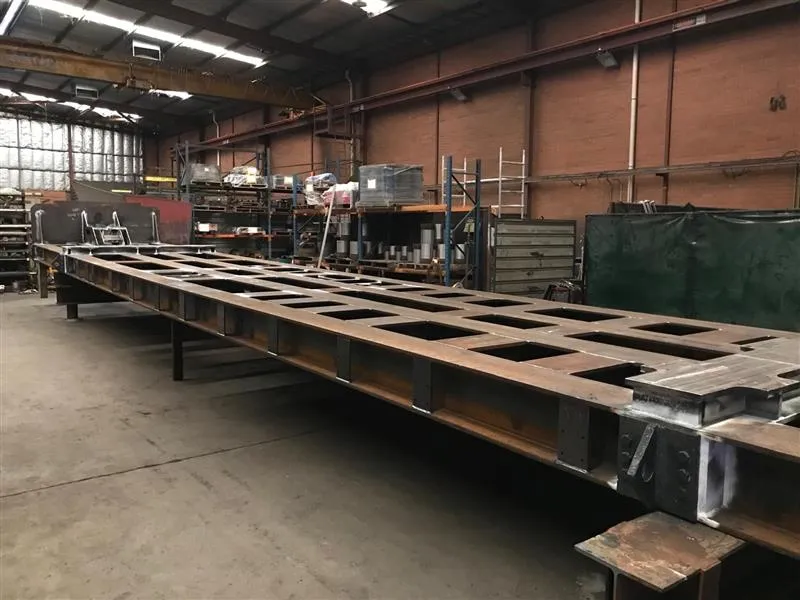 A fabricated steel frame under the overhead crane in the fabrication shop